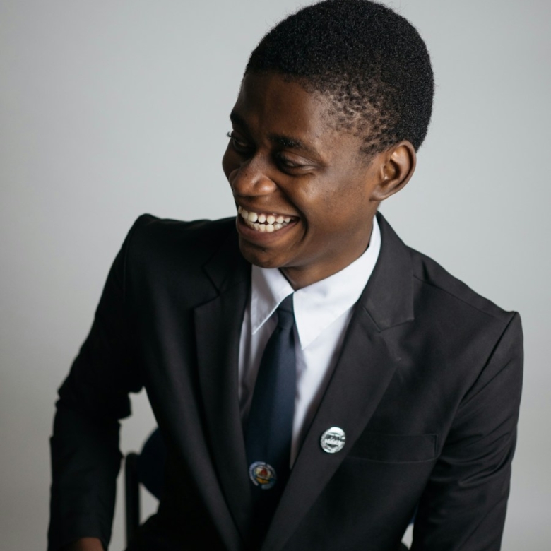 man wearing suit jacket and white painted wall